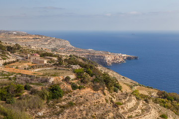 Fototapeta na wymiar Limestone rocks and azure sea of Malta island. Panoramic view.