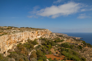 Fototapeta na wymiar Limestone rocks and azure sea of Malta island. Panoramic view.