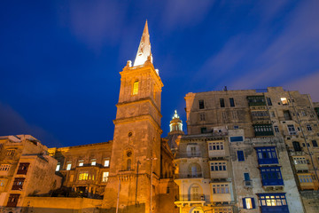 Fototapeta premium Tower and cathedral of Valetta. Night cityscape. Close up.