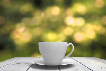 3d rendering. close up on White ceramic coffee cup on white wood table with blurred green garden bokeh as background
