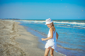 Happy little Girl on the beach.