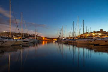 Night view of marina with sail boats and yachts. Malta island.