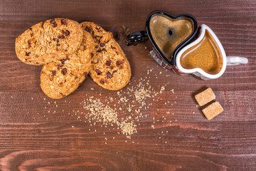 Lovely make up of morning coffee and breakfast. Couple coffee cup and biscuits on wooden background