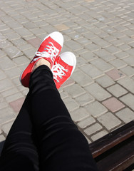 Woman in red sneakers on the street