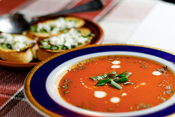 Tomato soup in a plate on a table