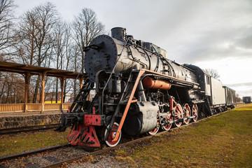 Obraz premium Old vintage steam locomotive from XX century, black and red color. Russian empire and USSR