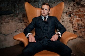 Sharp dressed dandy in a chair