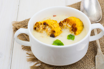 Cream soup with slices of corn grill