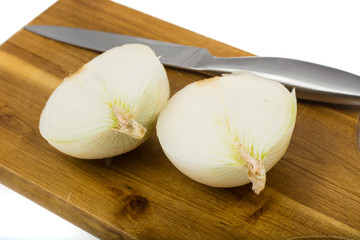 Halves of cut white onions on the cooking board