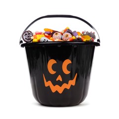 Black Halloween Jack o Lantern candy collector filled with candy over a white background © Jenifoto