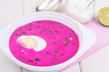 Cold beet soup in plate on light background