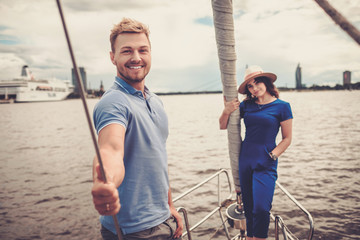 Happy couple resting on a yacht