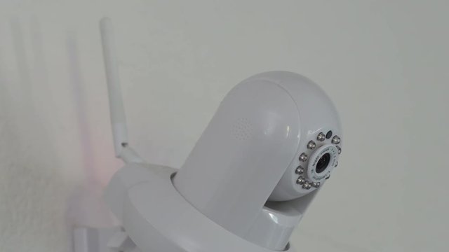 A High Definition wireless home security camera with antenna panning and tilting, moving around to get different views or follow something in the room.