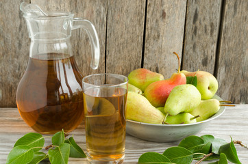 Pear fruits in aluminum plates and a carafe of pear juice