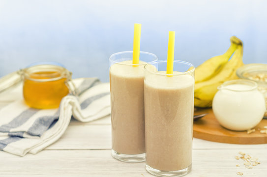 Banana smoothie. Milkshake with banana, honey and oatmeal. Oat smoothies. Healthy breakfast. Picture with space for text or logos