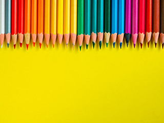 Colored pencil on yellow paper background for drawing color circle