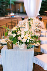 flower arrangement, design, spring concept. table numbered four decorated with help of florist that created stunning bouquet composed of avalanches and such verdure as brunch of raspberry and rosebush