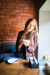 Fototapeta na wymiar woman in a cafe drinking coffee in the morning