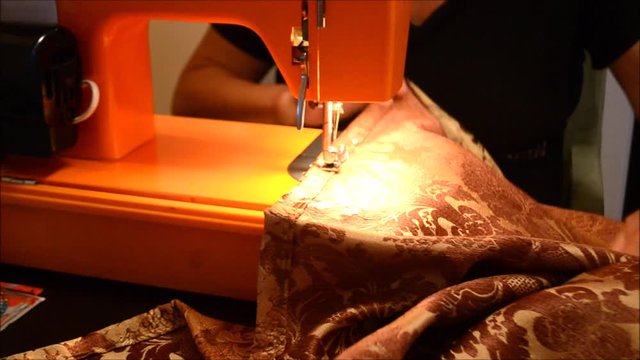 Crafter sewing a drape in her spare time at night