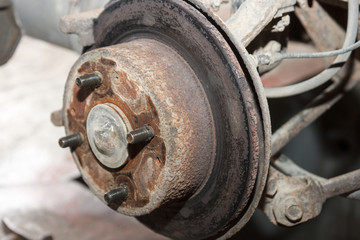 old broken rusty brake disc on an old car