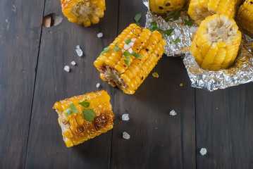 corn grilled on a wooden kitchen board with salt © vimart