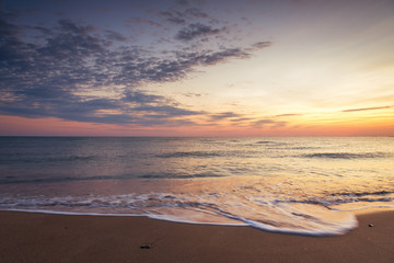 Majestic ocean sunrise with a breaking wave.