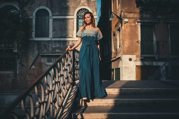 Fototapeta na wymiar Beautiful woman on a bridge in Venice, Italy