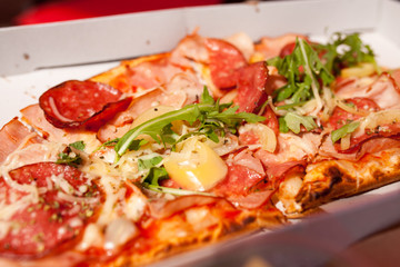 Pizza in close-up, straight from the oven. Melting mozzarella cheese over tomato base