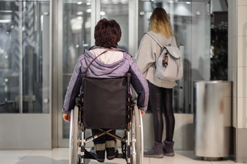 Disabled woman waiting for elevator