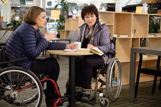 Two physically challenged women in a cafe