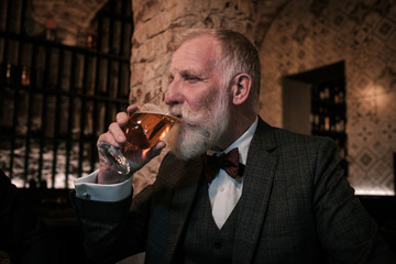 Senior gentleman tasting craft beer