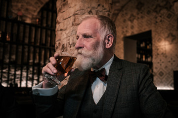 Senior gentleman tasting craft beer