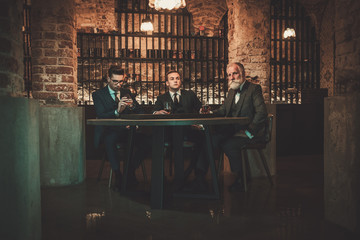 Senior and young gentlemen tasting craft beer