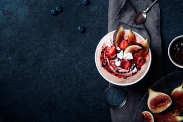 Almond milk bowl with strawberries and figs. Dark food phorography concept. Flatlay with copy space
