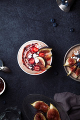 Almond milk bowl with strawberries and figs. Dark food phorography concept. Flatlay with copy space