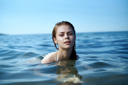 Beautiful woman is swimming in the sea, portrait