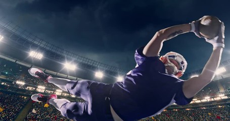 American football player jumps with a ball