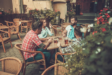 Good old friends drinking beer in a pub