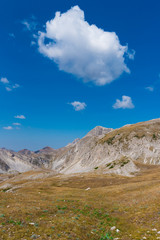 A high mountain range with peaks and plateaus on a warm summer day