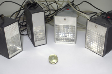 Old pulse electronic flashes, surrounding the small glass ball