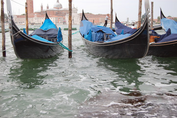  Gondolas docked on the Grand Canal near San Marco with St Giorgio in the background. Venice. Italy 