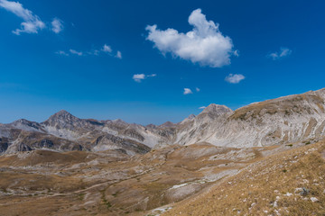 A high mountain range with peaks and plateaus on a warm summer day