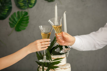 Romantic first date. Bride and groom at wedding banquet or party. Clinking on date or wedding day. Wine or champagne glasses	
