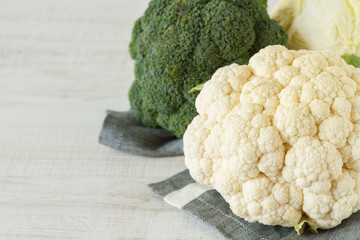 Fresh raw cauliflower and broccoli on a kitchen table