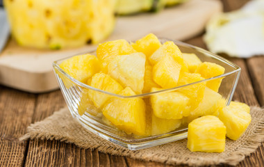 Portion of Pineapple (sliced) on wooden background, selective focus
