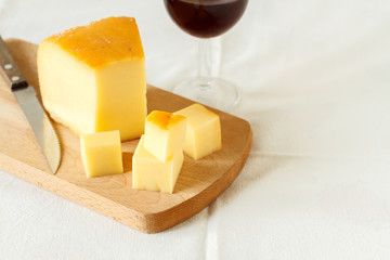 Still life composition with red wine and homemade rustic cheese