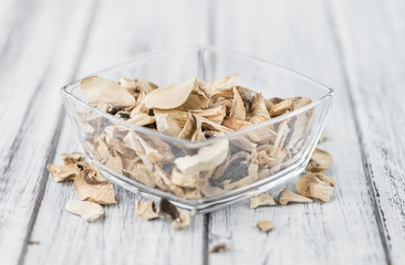 Wooden table with Dried white Mushrooms, selective focus