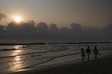 A person walking on the beach at dawn