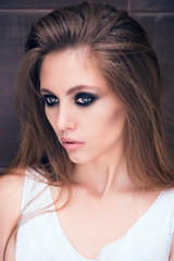 Face of beautiful brunette close-up. Beautiful, young brunette. Well retouched portrait. Without filters. Natural color. Toned image.