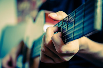 musician playing acoustic guitar, live music background